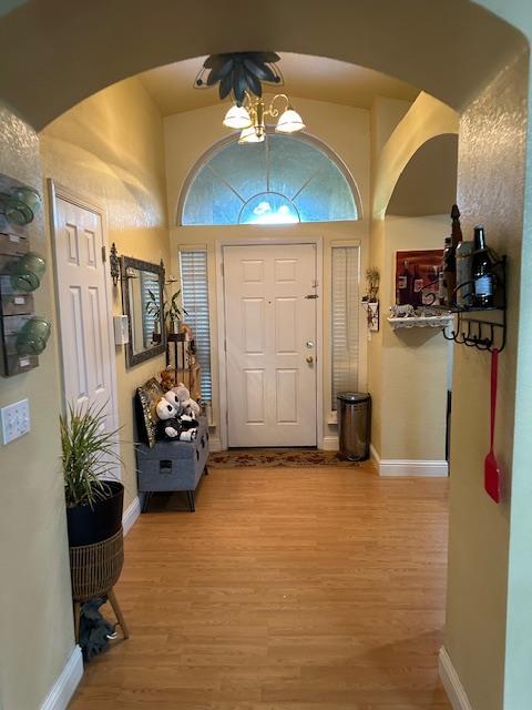 6675 N Lola Ave, Fresno, CA 93722 - foyer with arched walkways and light wood finished floors