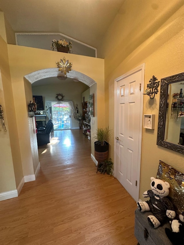 6675 N Lola Ave, Fresno, CA 93722 - hallway with arched walkways and light wood-type flooring