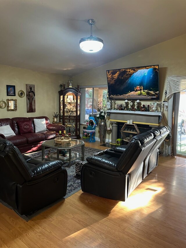 6675 N Lola Ave, Fresno, CA 93722 - living area featuring wood finished floors and lofted ceiling