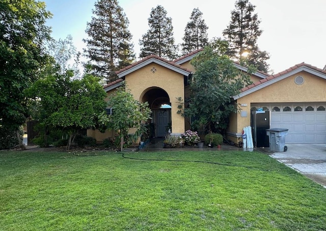6675 N Lola Ave, Fresno, CA 93722 - mediterranean / spanish home with stucco siding, a tiled roof, a garage, and a front yard