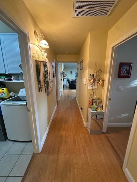 6675 N Lola Ave, Fresno, CA 93722 - hall featuring washer / dryer and light wood finished floors