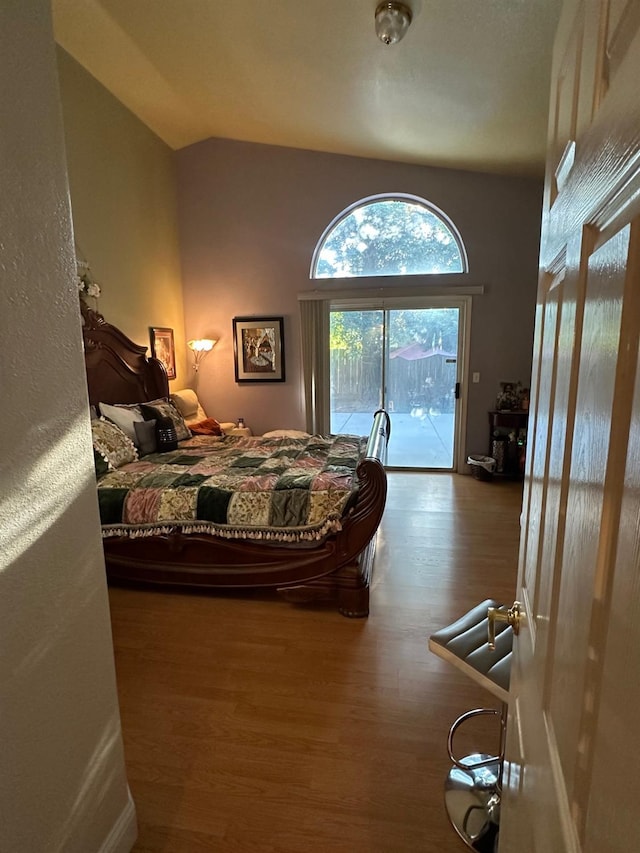 6675 N Lola Ave, Fresno, CA 93722 - bedroom featuring access to exterior, wood finished floors, and vaulted ceiling