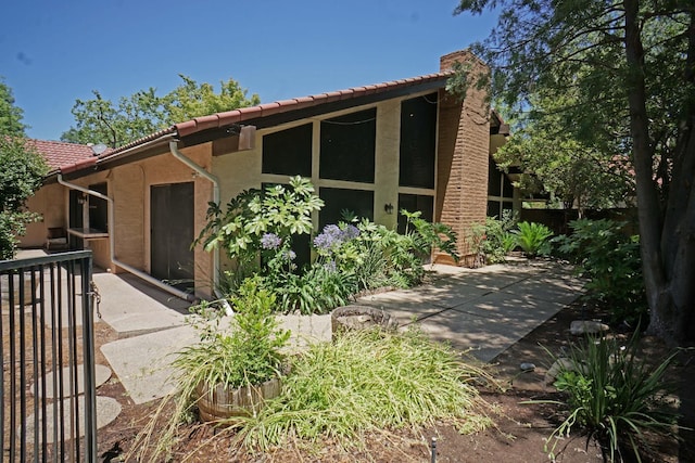 5513 N El Adobe Dr, Fresno, CA 93711 - view of front of property with a patio area, a tile roof, and stucco siding