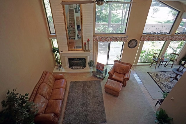 5513 N El Adobe Dr, Fresno, CA 93711 - tiled living room with a towering ceiling, a fireplace with raised hearth, and a ceiling fan