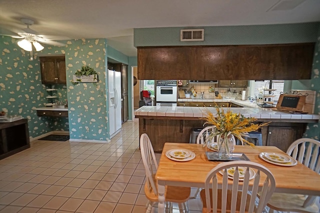 5513 N El Adobe Dr, Fresno, CA 93711 - dining area featuring wallpapered walls, light tile patterned floors, and ceiling fan