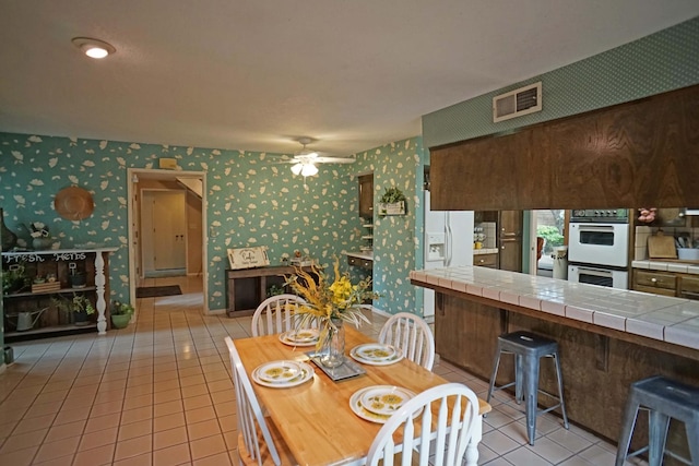 5513 N El Adobe Dr, Fresno, CA 93711 - dining room featuring wallpapered walls, light tile patterned floors, and ceiling fan