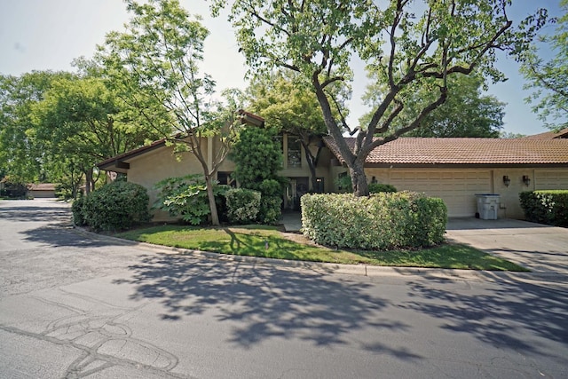 5513 N El Adobe Dr, Fresno, CA 93711 - view of front of home featuring a garage, stucco siding, driveway, and a tiled roof