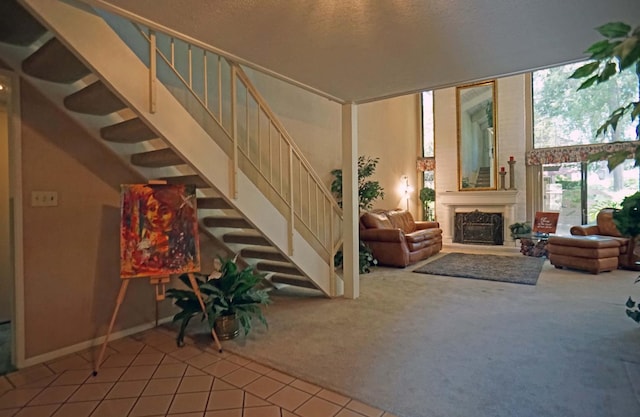 5513 N El Adobe Dr, Fresno, CA 93711 - tiled living room with carpet, stairs, and a fireplace with raised hearth