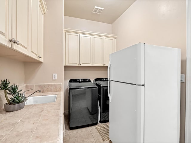 1568 E Sterling Hill Way, Fresno, CA 93730 - laundry area featuring light tile patterned floors, washer and dryer, and cabinet space