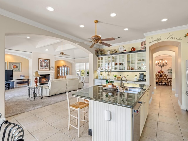 1568 E Sterling Hill Way, Fresno, CA 93730 - kitchen featuring arched walkways, a ceiling fan, recessed lighting, a glass covered fireplace, and light tile patterned floors