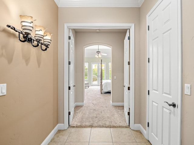 1568 E Sterling Hill Way, Fresno, CA 93730 - hall featuring light carpet, crown molding, light tile patterned floors, and arched walkways