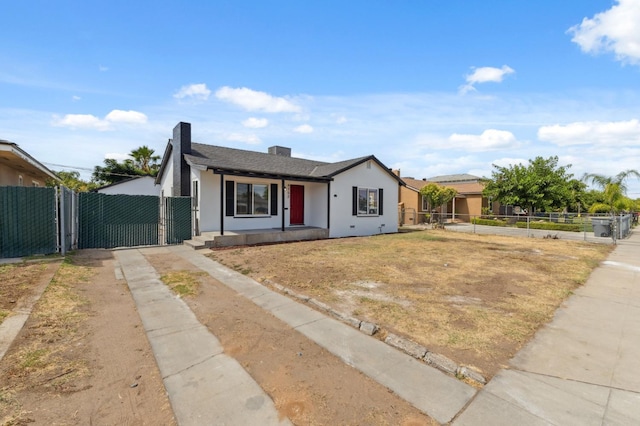 4752 E Kerckhoff Ave, Fresno, CA 93702 - view of front of home with driveway, a gate, and stucco siding