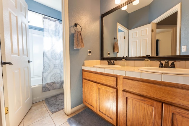 1774 Castle Way, Lemoore, CA 93245 - full bath with double vanity, tile patterned floors, shower / tub combo with curtain, and a textured wall