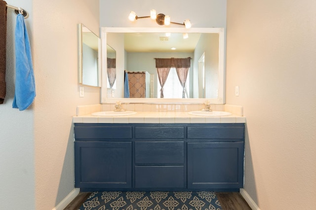 1774 Castle Way, Lemoore, CA 93245 - bathroom with double vanity and wood finished floors