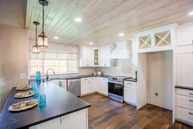 2540 Burgan Ave, Clovis, CA 93611 - kitchen featuring appliances with stainless steel finishes, custom exhaust hood, dark countertops, wooden ceiling, and glass insert cabinets