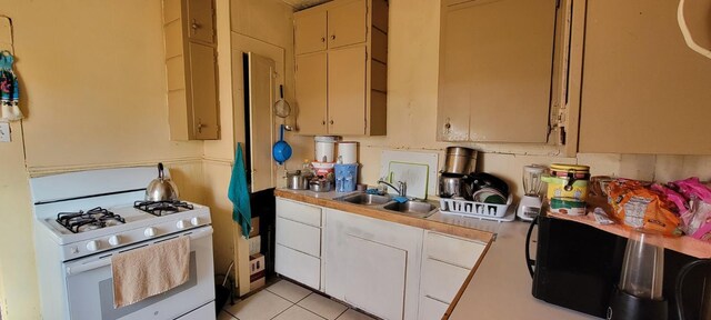 10691 Jones St, Riverdale, CA 93656 - kitchen featuring gas range gas stove, light countertops, and light tile patterned flooring