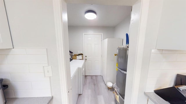 491 W Fir Ave, Pinedale, CA 93650 - washroom with washing machine and dryer, light wood-type flooring, and gas water heater