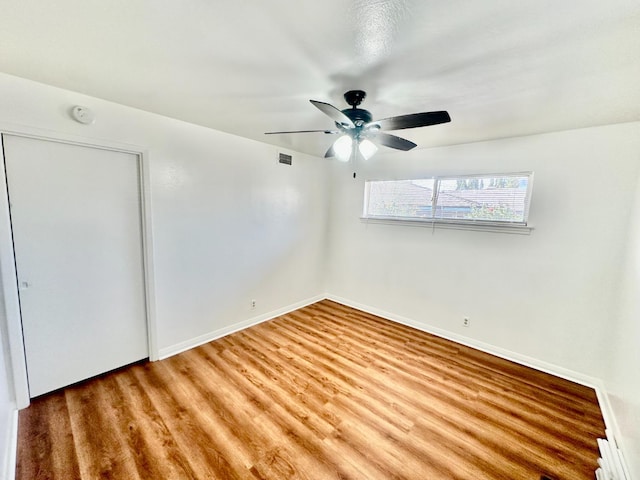 535 W Peralta Way, Fresno, CA 93705 - unfurnished bedroom featuring wood finished floors and ceiling fan