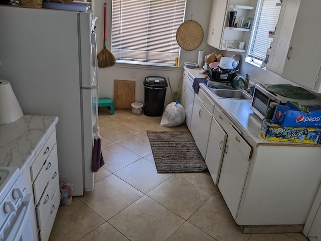 535 W Peralta Way, Fresno, CA 93705 - kitchen featuring white appliances, white cabinetry, light countertops, and light tile patterned flooring