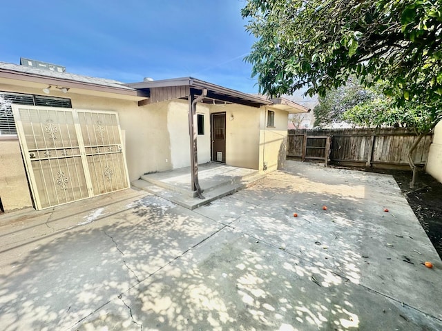 535 W Peralta Way, Fresno, CA 93705 - back of house featuring stucco siding and a patio