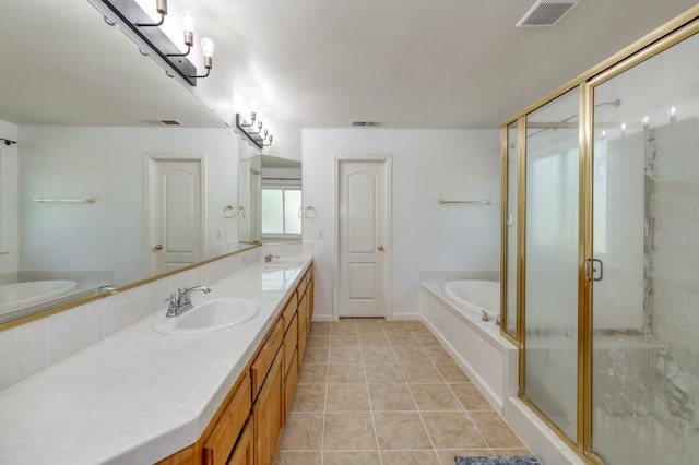 7718 N Constance Ave, Fresno, CA 93722 - bathroom featuring a garden tub, double vanity, a shower stall, and tile patterned flooring