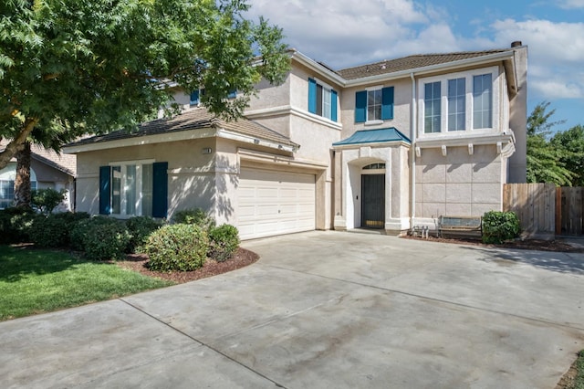 7718 N Constance Ave, Fresno, CA 93722 - traditional-style home with stucco siding, driveway, a garage, and a chimney