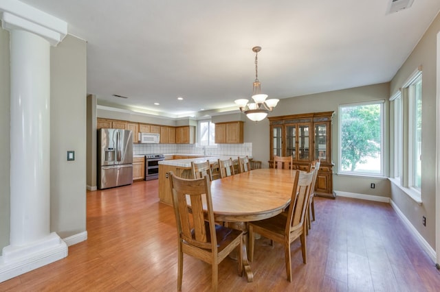7718 N Constance Ave, Fresno, CA 93722 - dining room featuring decorative columns, a chandelier, light wood-style floors, and recessed lighting