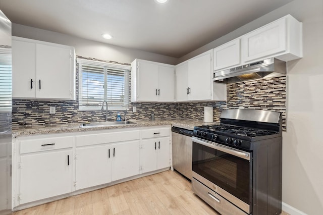 8620 La Vaca Way, Hanford, CA 93230 - kitchen featuring stainless steel appliances, under cabinet range hood, light wood-type flooring, light countertops, and white cabinetry