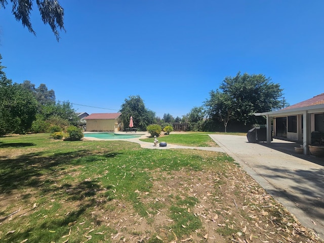 36883 Cloverleaf Ave, Madera, CA 93636 - view of grassy yard featuring a patio and an outdoor pool