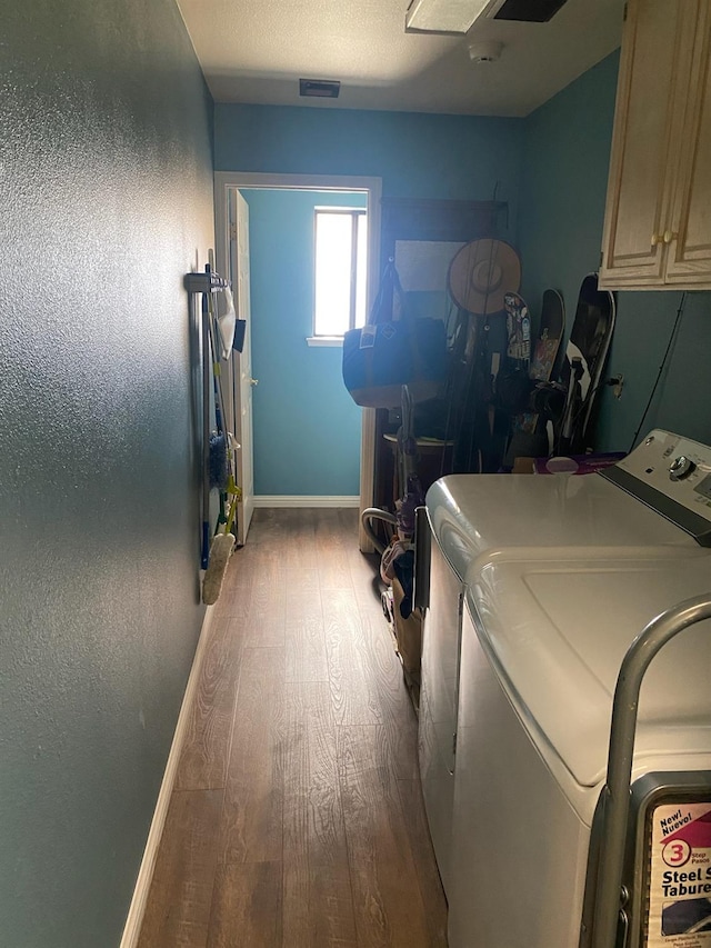 36883 Cloverleaf Ave, Madera, CA 93636 - washroom featuring washing machine and dryer, cabinet space, and wood finished floors