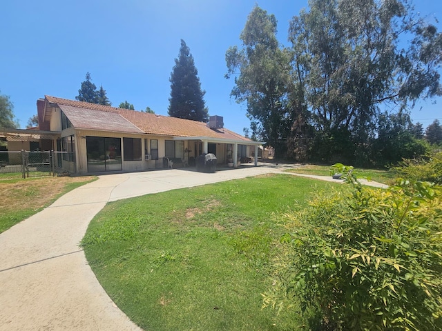 36883 Cloverleaf Ave, Madera, CA 93636 - back of house with a chimney, a tile roof, and a patio area