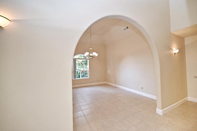 8037 E Morab Ave, Clovis, CA 93619 - unfurnished room featuring a chandelier, arched walkways, and light tile patterned flooring