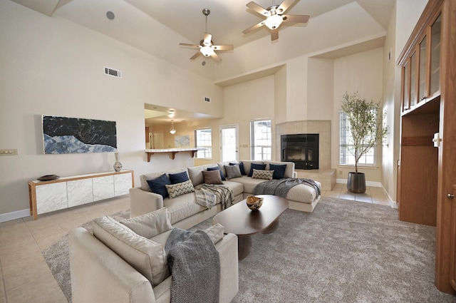 8037 E Morab Ave, Clovis, CA 93619 - tiled living area with healthy amount of natural light, a ceiling fan, a towering ceiling, and a fireplace