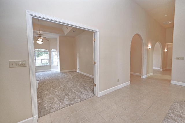 8037 E Morab Ave, Clovis, CA 93619 - corridor featuring light tile patterned floors, arched walkways, light colored carpet, and a high ceiling