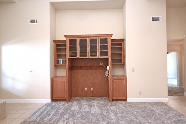 8037 E Morab Ave, Clovis, CA 93619 - unfurnished living room with light tile patterned floors, light carpet, and ceiling fan