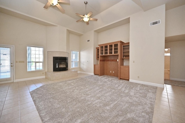 8037 E Morab Ave, Clovis, CA 93619 - unfurnished living room with high vaulted ceiling, light tile patterned floors, ceiling fan, and a fireplace
