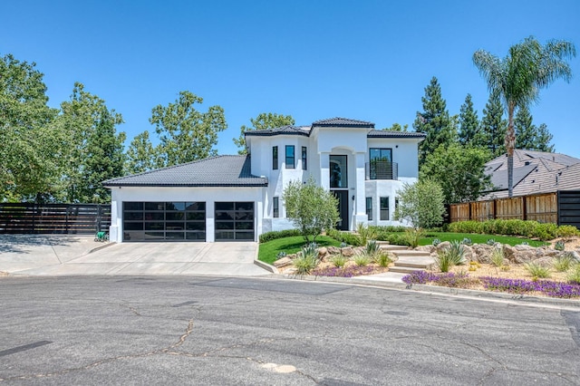 1292 E Valley Forge Dr, Fresno, CA 93720 - mediterranean / spanish home featuring a tiled roof, driveway, an attached garage, and stucco siding
