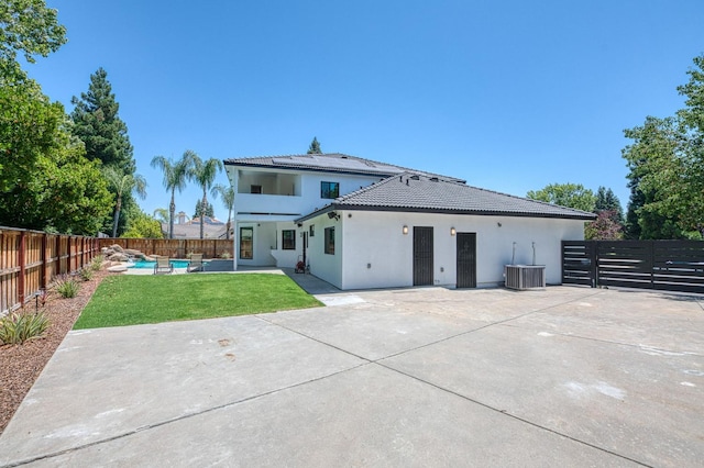 1292 E Valley Forge Dr, Fresno, CA 93720 - rear view of house with a fenced backyard, a tile roof, stucco siding, and a patio area