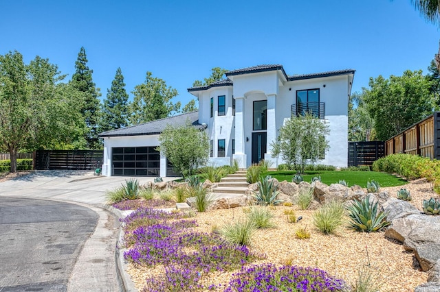 1292 E Valley Forge Dr, Fresno, CA 93720 - mediterranean / spanish house with a tiled roof, stucco siding, a garage, and concrete driveway