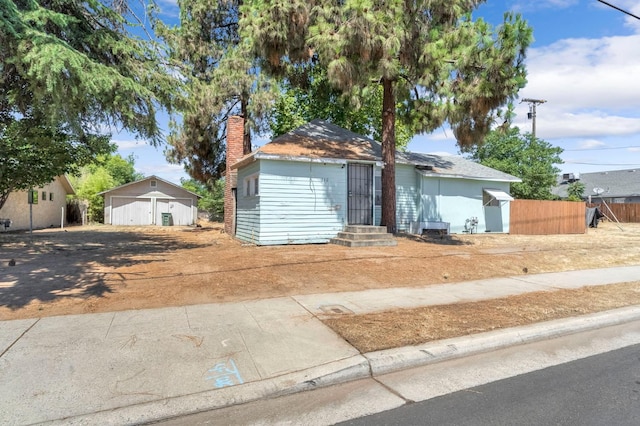 760 Sunnyside Ave, Clovis, CA 93611 - ranch-style home with entry steps, a chimney, a garage, driveway, and an outdoor structure