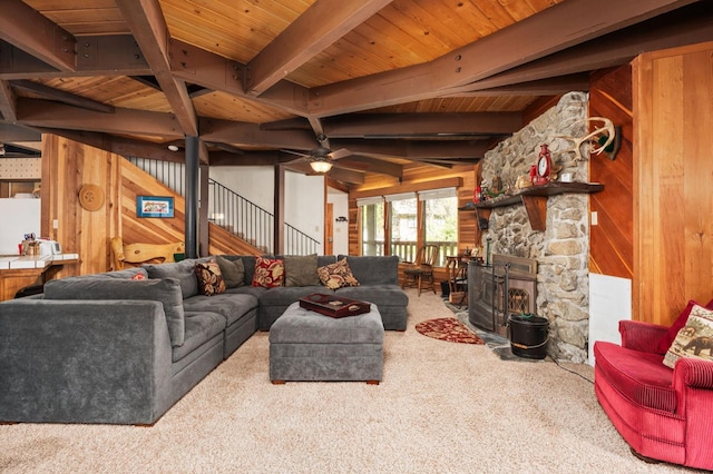 42215 Rock Ledge Rd, Shaver Lake, CA 96161 - carpeted living room featuring wood walls, stairs, a wooden ceiling with exposed beams, ceiling fan, and a fireplace