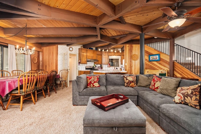 42215 Rock Ledge Rd, Shaver Lake, CA 96161 - living room with wood walls, light colored carpet, a chandelier, a wooden ceiling with exposed beams, and ceiling fan