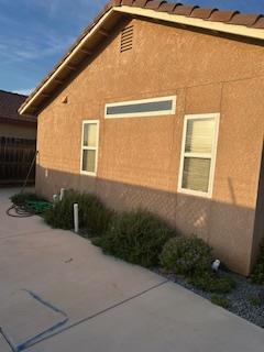 220 S Double Tree Way, Madera, CA 93637 - view of side of home featuring stucco siding and a patio