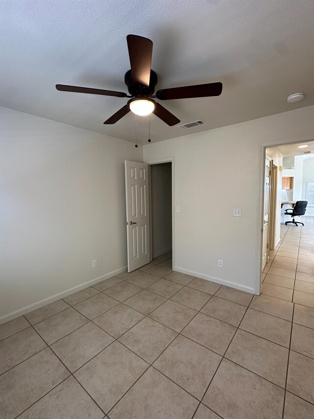 220 S Double Tree Way, Madera, CA 93637 - empty room featuring light tile patterned floors, ceiling fan, and a textured ceiling