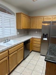 220 S Double Tree Way, Madera, CA 93637 - kitchen with appliances with stainless steel finishes, light tile patterned flooring, tile counters, and tasteful backsplash