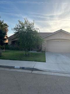 220 S Double Tree Way, Madera, CA 93637 - view of front of home with a garage, concrete driveway, and a front yard