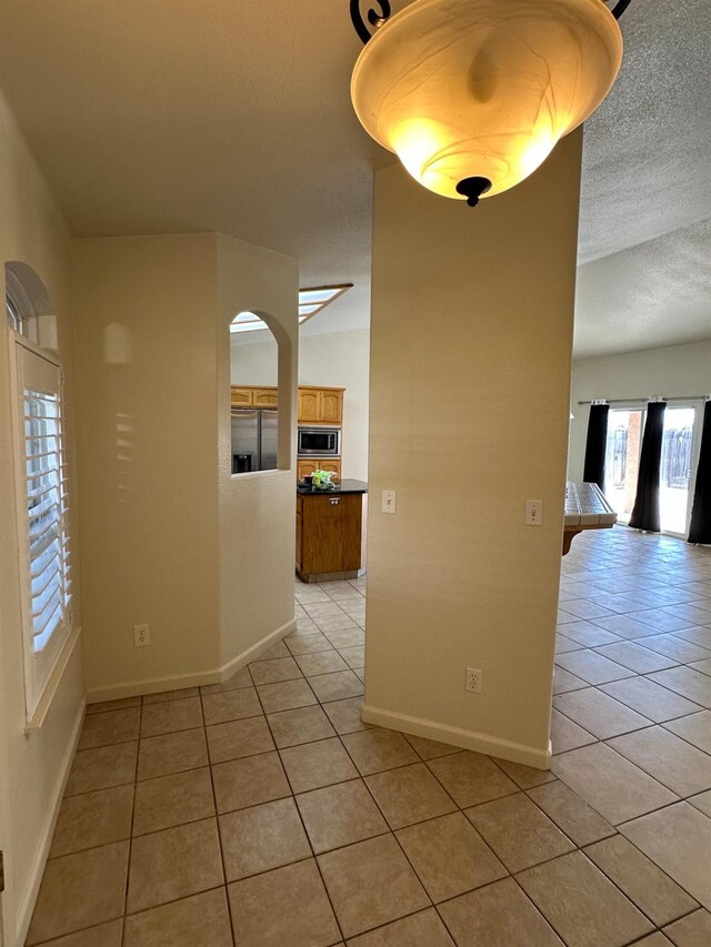 220 S Double Tree Way, Madera, CA 93637 - empty room with light tile patterned floors and a textured ceiling