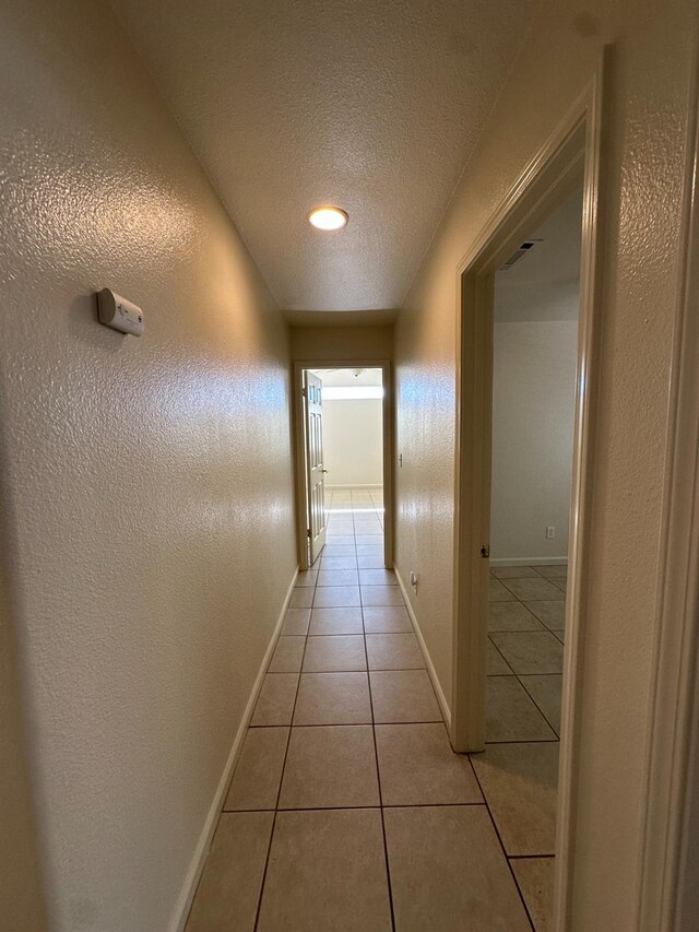220 S Double Tree Way, Madera, CA 93637 - hallway featuring light tile patterned flooring and a textured ceiling