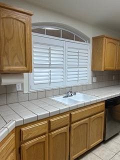 220 S Double Tree Way, Madera, CA 93637 - kitchen with dishwasher, tile countertops, light tile patterned floors, and backsplash