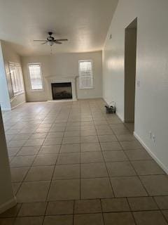 220 S Double Tree Way, Madera, CA 93637 - unfurnished living room featuring ceiling fan, tile patterned floors, and a fireplace